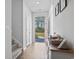 Bright entryway featuring hardwood floors, a red front door, and a view of the outdoors at 4005 Sweetspire Court, Conway, SC 29526