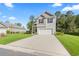 Well-manicured lawn complements this home featuring a two-car garage and a classic design with gray accents at 4005 Sweetspire Court, Conway, SC 29526