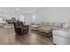 Spacious living room with hardwood floors, a plush gray sectional sofa, and plenty of natural light at 4005 Sweetspire Court, Conway, SC 29526