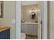 Stylish bathroom with white cabinets and a modern light fixture over the round mirror at 401 77Th Ave. N # 11, Myrtle Beach, SC 29572