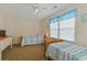 Bright bedroom featuring two twin beds with blue striped bedding and a large window at 401 77Th Ave. N # 11, Myrtle Beach, SC 29572
