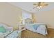 Relaxing bedroom with a queen-size bed, ceiling fan, and a cozy sitting area at 401 77Th Ave. N # 11, Myrtle Beach, SC 29572