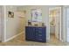 Hallway with a blue cabinet and drawers, featuring a coffee maker, toaster, and access to the bathroom at 401 77Th Ave. N # 11, Myrtle Beach, SC 29572