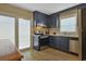 Modern kitchen with dark cabinets, stainless steel appliances, and sliding glass door access to outdoor space at 401 77Th Ave. N # 11, Myrtle Beach, SC 29572