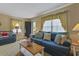 Comfortable living room with plush seating, decorative pillows, and large windows with natural light at 401 77Th Ave. N # 11, Myrtle Beach, SC 29572