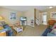 Cozy living room with comfortable seating, coastal-themed decor, and a staircase to the upper level at 401 77Th Ave. N # 11, Myrtle Beach, SC 29572