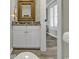 Well-lit half bath with a decorative mirror, granite countertop, and stylish vanity at 407 15Th Ave. S, North Myrtle Beach, SC 29582