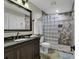 Modern bathroom featuring a glass block shower, a dark vanity, and neutral tile at 407 15Th Ave. S, North Myrtle Beach, SC 29582