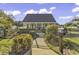 Charming home featuring a well-kept lawn, black fence, and inviting front porch, offering curb appeal at 407 15Th Ave. S, North Myrtle Beach, SC 29582