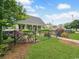Charming home featuring a well-kept lawn, black fence, and mature landscaping, offering curb appeal at 407 15Th Ave. S, North Myrtle Beach, SC 29582