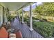 Inviting front porch featuring classic columns and comfortable seating with beautifully maintained landscaping at 407 15Th Ave. S, North Myrtle Beach, SC 29582