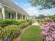 Landscaped front yard with lush greenery and blooming flowers, enhancing the home's welcoming appeal at 407 15Th Ave. S, North Myrtle Beach, SC 29582