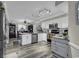 Spacious kitchen with white cabinets, granite countertops, modern appliances, and wooden floors at 407 15Th Ave. S, North Myrtle Beach, SC 29582