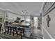 Kitchen island with granite countertop, stool seating, modern appliances, and stylish backsplash at 407 15Th Ave. S, North Myrtle Beach, SC 29582