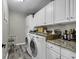 Laundry room featuring modern washer and dryer, ample cabinet space, and granite countertops at 407 15Th Ave. S, North Myrtle Beach, SC 29582