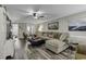 Bright living room with hardwood floors, neutral paint, ceiling fan and large comfortable couch at 407 15Th Ave. S, North Myrtle Beach, SC 29582