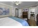 Serene primary bedroom with a wooden dresser, modern ceiling fan, and hardwood floors at 407 15Th Ave. S, North Myrtle Beach, SC 29582