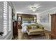 Inviting primary bedroom with a sitting area, accent wall, and large windows at 407 15Th Ave. S, North Myrtle Beach, SC 29582