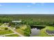 Aerial view of property showcasing the home, pond, surrounding landscape, and address at 4084 Hagwood Circle, Conway, SC 29526