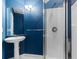 Modern bathroom featuring a walk-in shower, pedestal sink, and a decorative light fixture at 4084 Hagwood Circle, Conway, SC 29526
