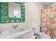 Unique bathroom featuring a vibrant mirror, sink, toilet, and tropical themed shower curtain at 4084 Hagwood Circle, Conway, SC 29526