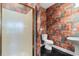 Bathroom with glass shower door, unique wallpaper, black tile flooring, and pedestal sink at 4084 Hagwood Circle, Conway, SC 29526