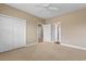 Spacious bedroom featuring plush carpeting, ceiling fan and access to the ensuite bathroom and closets at 4084 Hagwood Circle, Conway, SC 29526