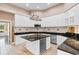 Bright kitchen with white cabinets, dark countertops, stainless appliances, and center island with a wine cooler at 4084 Hagwood Circle, Conway, SC 29526