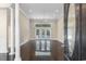 Bright living room featuring elegant columns, tile flooring, and double doors leading to the backyard pool at 4084 Hagwood Circle, Conway, SC 29526