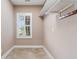Functional mud room with tile floor, window with shutters, and shelving with coat hooks at 4084 Hagwood Circle, Conway, SC 29526