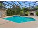 Inviting screened-in pool area with attached hot tub, surrounded by lush greenery at 4084 Hagwood Circle, Conway, SC 29526