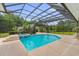 Captivating screened-in pool with a hot tub and outdoor seating nestled amongst lush greenery at 4084 Hagwood Circle, Conway, SC 29526