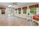 Bright sunroom featuring tile flooring, large windows with plaid valances, and glass sliding door to outside at 4084 Hagwood Circle, Conway, SC 29526