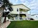 Backyard featuring an entertainment area, staircase, lush lawn, and mature palm tree at 412 29Th Ave. N, North Myrtle Beach, SC 29582
