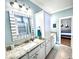 Bright bathroom with granite countertops, white cabinetry, and neutral tile flooring at 412 29Th Ave. N, North Myrtle Beach, SC 29582