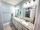 Bright bathroom featuring dual sinks, granite countertops, and modern lighting at 412 29Th Ave. N, North Myrtle Beach, SC 29582