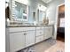 Well-lit bathroom with double sinks, granite counters, and decorative mirrors at 412 29Th Ave. N, North Myrtle Beach, SC 29582