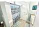 Bathroom featuring a blue patterned shower curtain and tile flooring at 412 29Th Ave. N, North Myrtle Beach, SC 29582