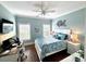 Light-filled bedroom with wood floors, ceiling fan, and white furnishings at 412 29Th Ave. N, North Myrtle Beach, SC 29582