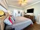 Bedroom featuring a large bed, hardwood floors, and a TV at 412 29Th Ave. N, North Myrtle Beach, SC 29582