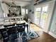 Bright dining area featuring a modern table, stylish chairs, and a sliding door that leads to outdoor view at 412 29Th Ave. N, North Myrtle Beach, SC 29582