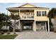 Charming elevated home with a covered porch, white railings, and ground-level covered parking at 412 29Th Ave. N, North Myrtle Beach, SC 29582