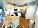 Modern kitchen with white cabinets, a breakfast bar, and stainless steel appliances at 412 29Th Ave. N, North Myrtle Beach, SC 29582