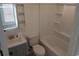Bright bathroom featuring a modern vanity, toilet, and tub-shower combination with built-in shelves at 418 C Tree Top Ct. # 0, Myrtle Beach, SC 29588