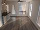 Sunlit dining area with wood-look flooring and large windows, perfect for entertaining guests at 418 C Tree Top Ct. # 0, Myrtle Beach, SC 29588