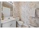 Compact bathroom featuring a single sink vanity and toilet with floral wallpaper at 4200 Coquina Harbour Dr. # H5, Little River, SC 29566