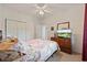 Bright bedroom with neutral carpet and comfortable floral themed bedding and dresser with television at 4200 Coquina Harbour Dr. # H5, Little River, SC 29566