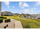 Beautifully landscaped grassy areas surrounding a marina complex with boats docked at 4200 Coquina Harbour Dr. # H5, Little River, SC 29566