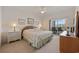 The main bedroom features a ceiling fan, balcony access, and warm natural light at 4200 Coquina Harbour Dr. # H5, Little River, SC 29566
