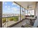 Relaxing screened patio seating area with ceiling fan, marina view and dining table set at 4200 Coquina Harbour Dr. # H5, Little River, SC 29566